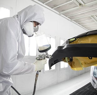 Collision Center Technician Painting a Vehicle | Fox Toyota of El Paso in El Paso TX