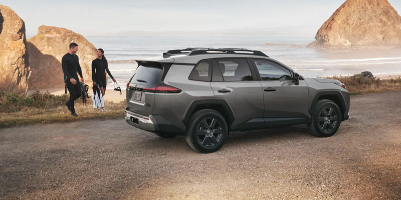Toyota RAV4 parked on a dirt road with the ocean visible in the background.